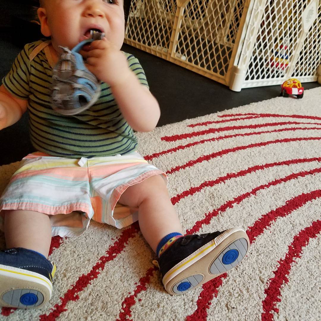Wearing some new kicks as he tries to eat the old ones.